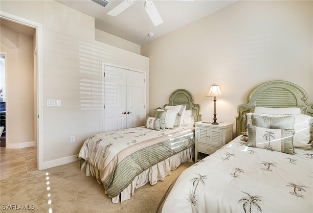 carpeted bedroom featuring ceiling fan and a closet