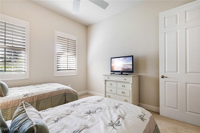 bedroom featuring light carpet and ceiling fan