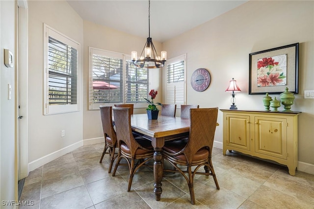 tiled dining space with an inviting chandelier