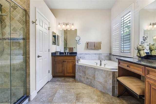 bathroom featuring vanity, separate shower and tub, and a wealth of natural light