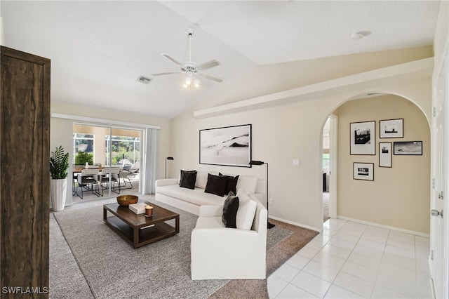 living room with lofted ceiling, light tile patterned floors, and ceiling fan