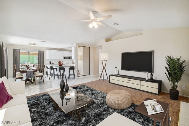 tiled living room featuring lofted ceiling and ceiling fan