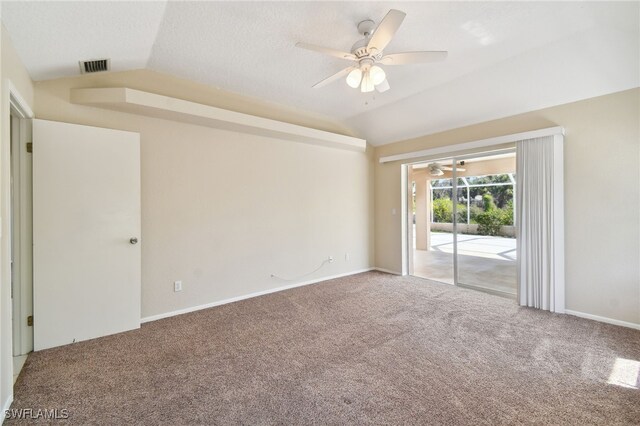 carpeted spare room featuring ceiling fan and vaulted ceiling