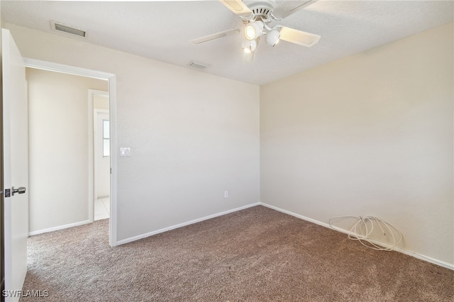 spare room featuring ceiling fan and carpet flooring