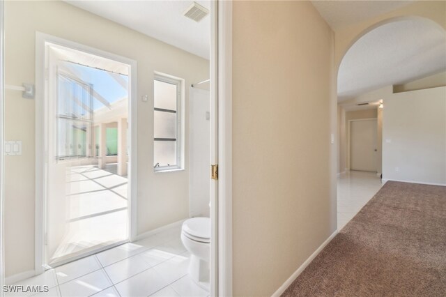 corridor featuring light tile patterned flooring