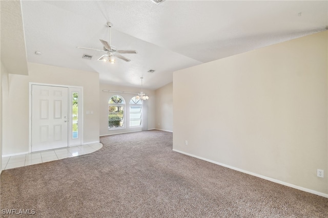 unfurnished living room with lofted ceiling, ceiling fan with notable chandelier, light colored carpet, and a textured ceiling