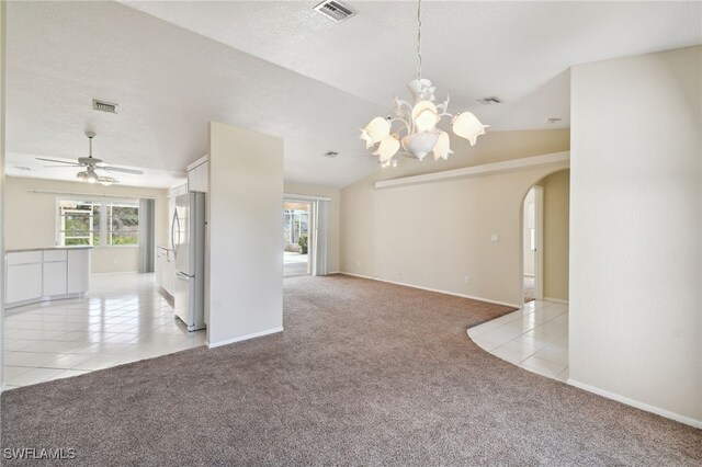 carpeted spare room featuring ceiling fan with notable chandelier and a textured ceiling