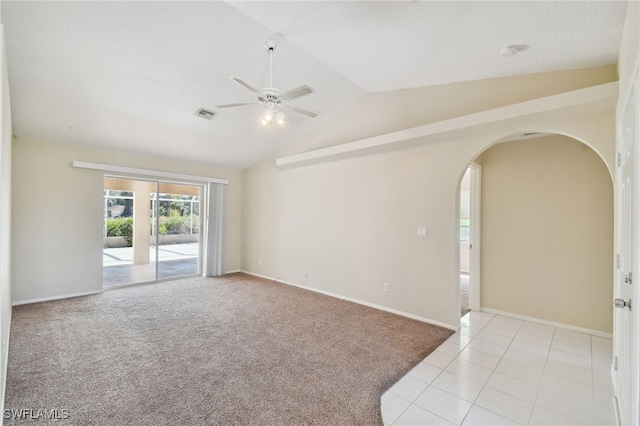 carpeted spare room with ceiling fan and vaulted ceiling