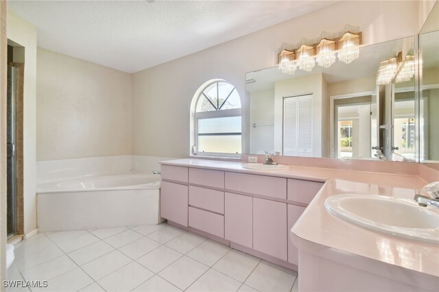 bathroom featuring tile patterned floors, plus walk in shower, and vanity