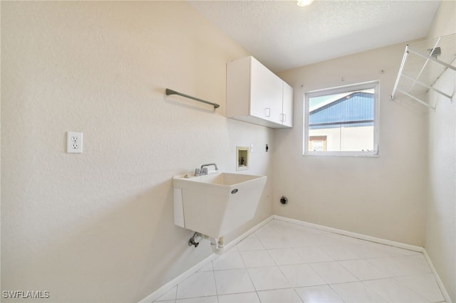 laundry room with sink, cabinets, a textured ceiling, washer hookup, and hookup for an electric dryer