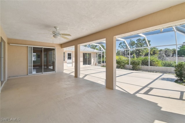 unfurnished sunroom featuring ceiling fan