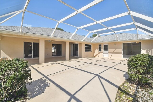 back of house with a lanai and a patio