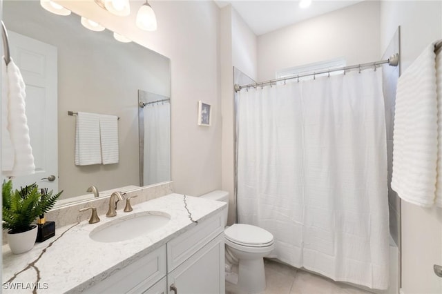 bathroom featuring tile patterned flooring, vanity, curtained shower, and toilet