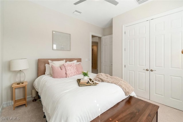 bedroom featuring ceiling fan, a closet, and light carpet