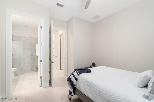 bedroom with light carpet, ensuite bath, and ceiling fan