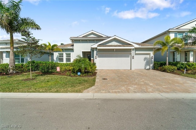 view of front of home with a garage and a front yard