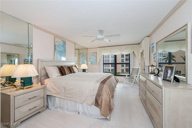 bedroom featuring ornamental molding, light hardwood / wood-style floors, and multiple windows