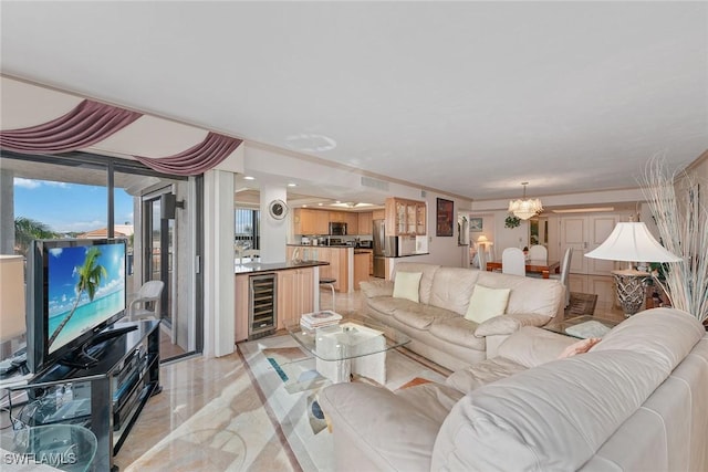 living room featuring a notable chandelier and beverage cooler