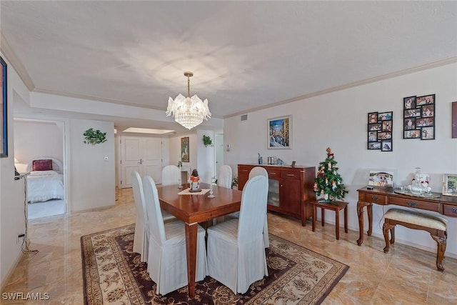 dining room with ornamental molding and an inviting chandelier