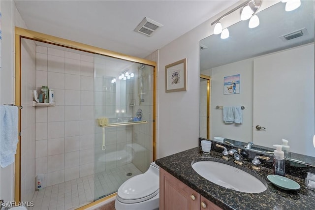 bathroom with walk in shower, vanity, and toilet