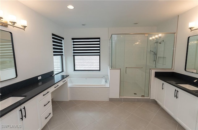 20341 Fair Oak Ln, Estero, FL 33928 - full bath featuring tile patterned floors, a stall shower, a bath, two vanities, and recessed lighting