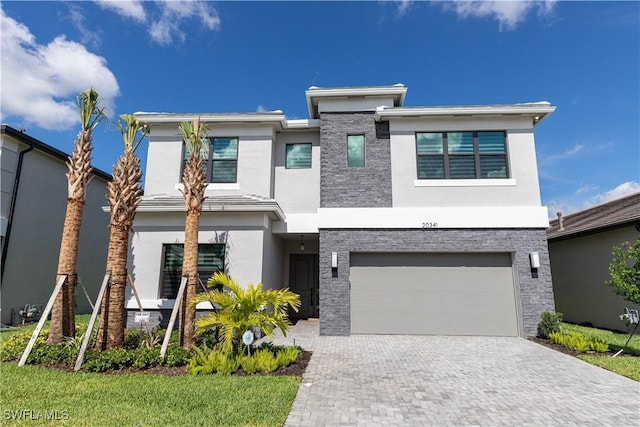 20341 Fair Oak Ln, Estero, FL 33928 - view of front of house with stucco siding, a garage, and decorative driveway