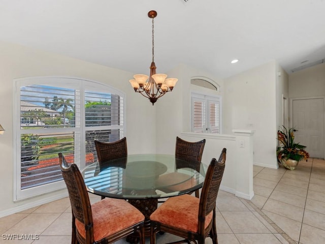 dining room featuring lofted ceiling, baseboards, an inviting chandelier, and light tile patterned floors