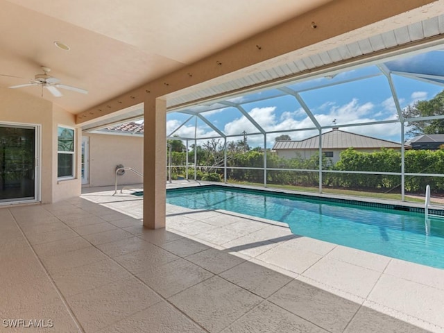 pool featuring a lanai, a patio area, and a ceiling fan