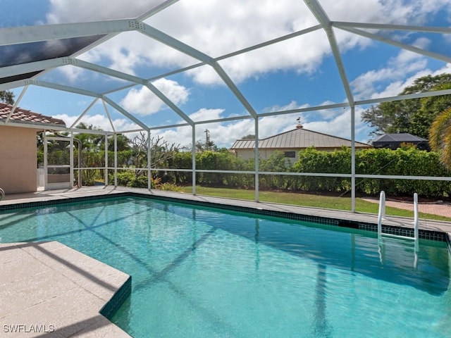 outdoor pool featuring glass enclosure