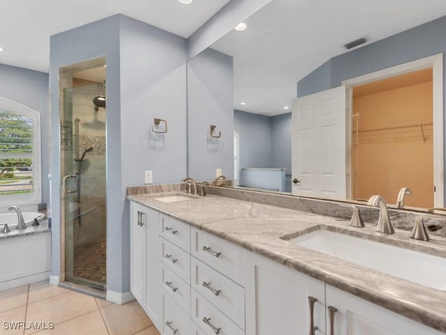 bathroom featuring tile patterned flooring, a sink, visible vents, and a shower stall