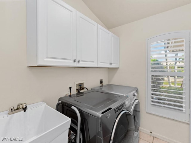 laundry area with light tile patterned floors, cabinet space, a sink, independent washer and dryer, and baseboards