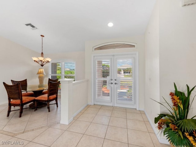 foyer entrance featuring french doors, a notable chandelier, light tile patterned floors, visible vents, and baseboards