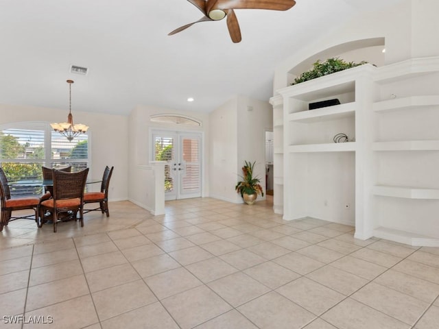 interior space with built in features, french doors, light tile patterned floors, visible vents, and ceiling fan with notable chandelier