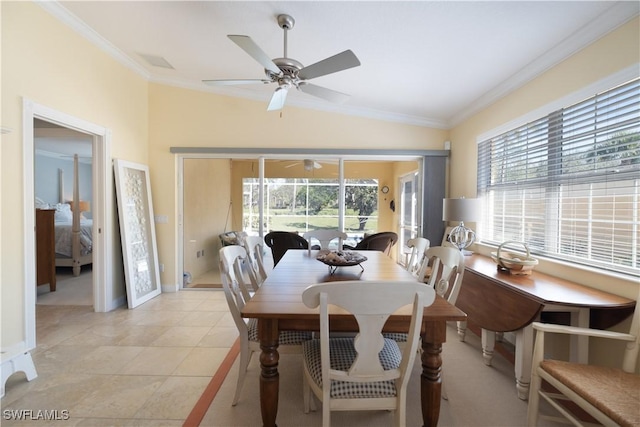 dining room with crown molding, vaulted ceiling, and a wealth of natural light