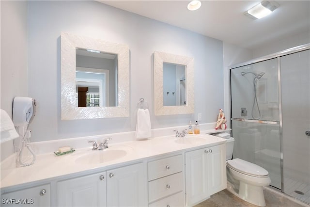 bathroom with vanity, tile patterned floors, a shower with door, and toilet