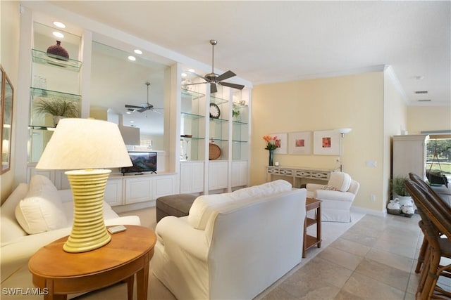 living room with crown molding, ceiling fan, and light tile patterned flooring