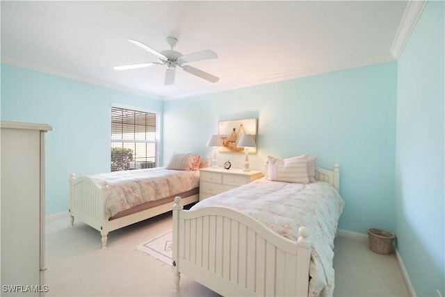 carpeted bedroom with ornamental molding and ceiling fan