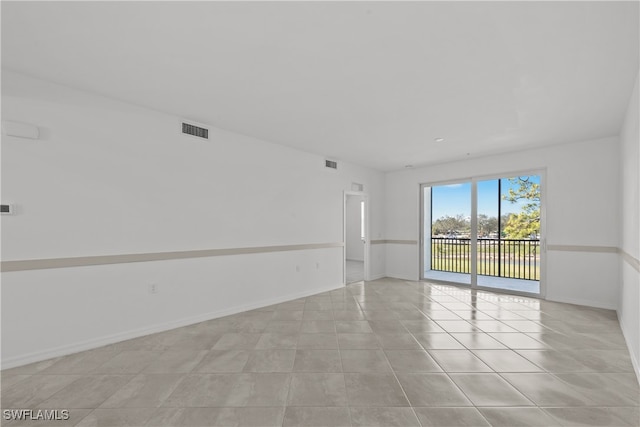 empty room with light tile patterned floors