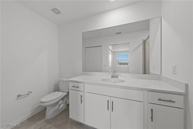 bathroom with vanity, an enclosed shower, tile patterned floors, and toilet