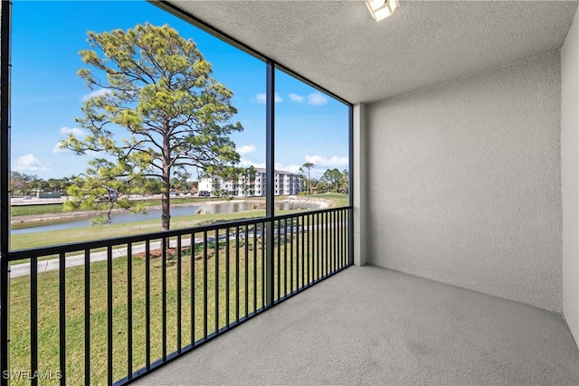 unfurnished sunroom with a water view