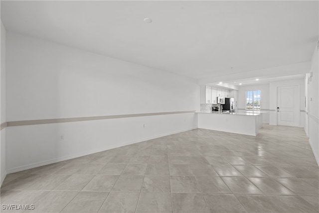 unfurnished living room with light tile patterned floors