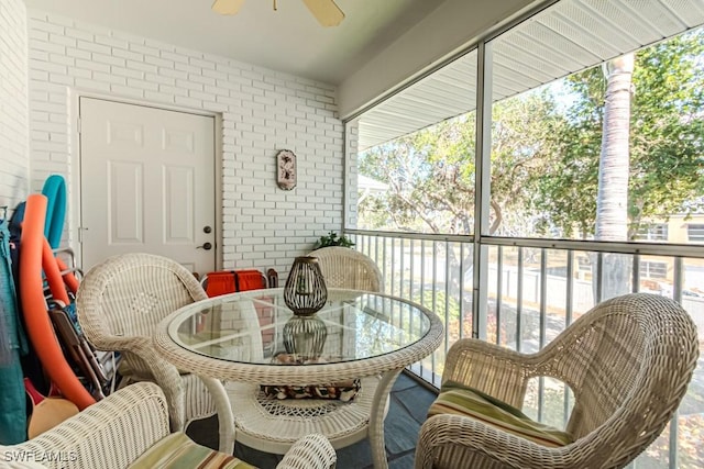 sunroom / solarium featuring a wealth of natural light and ceiling fan