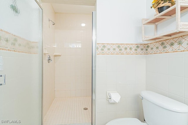 bathroom with walk in shower, toilet, and tile walls