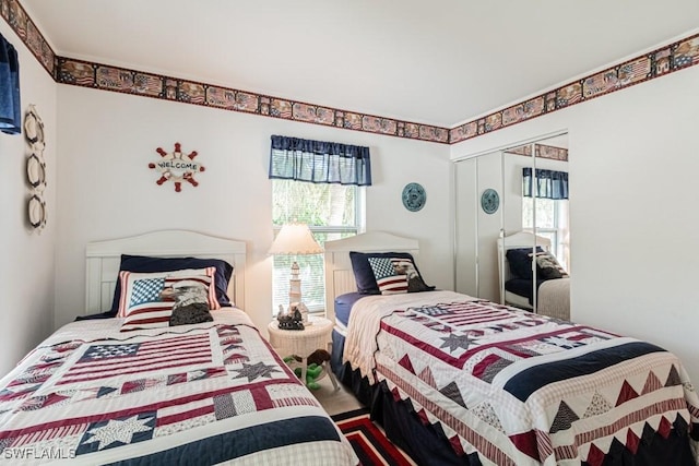 bedroom with a closet and multiple windows