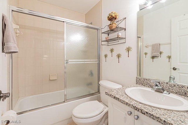 full bathroom featuring bath / shower combo with glass door, vanity, and toilet