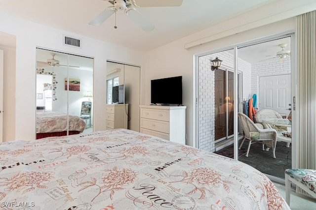 bedroom with ceiling fan and multiple closets