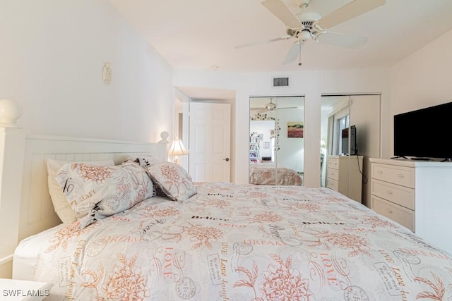 bedroom featuring multiple closets and ceiling fan