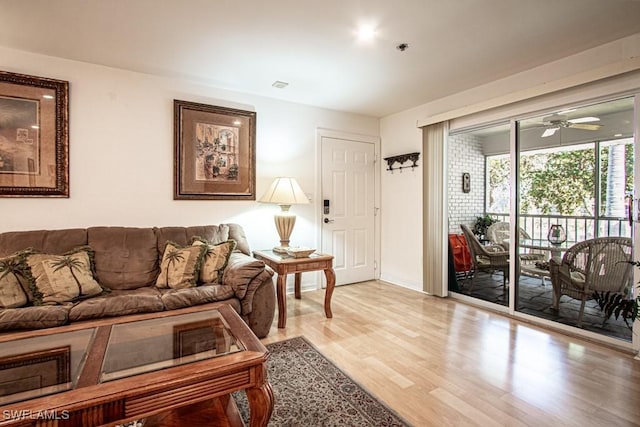 living room featuring light hardwood / wood-style flooring and ceiling fan