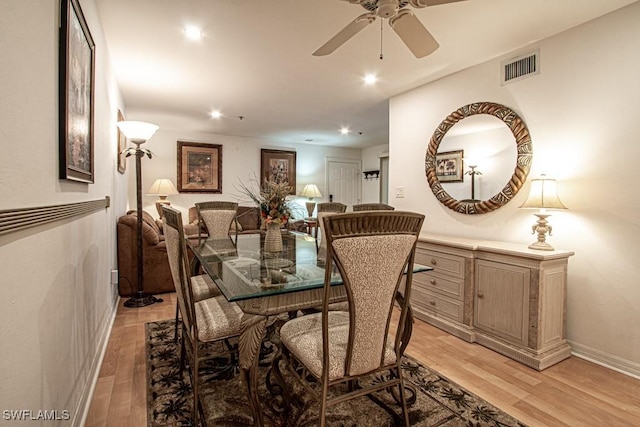 dining area with light hardwood / wood-style flooring and ceiling fan