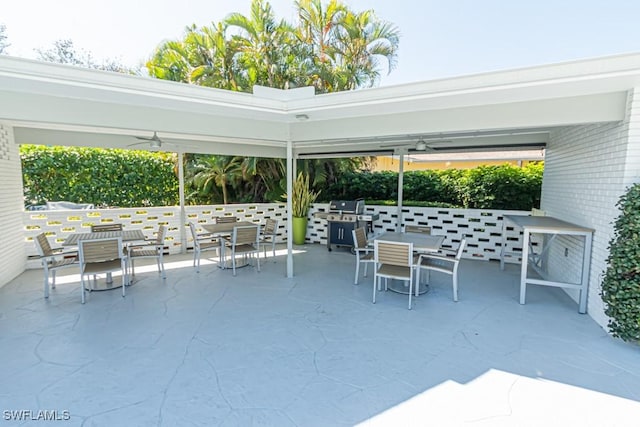 view of patio with ceiling fan and grilling area